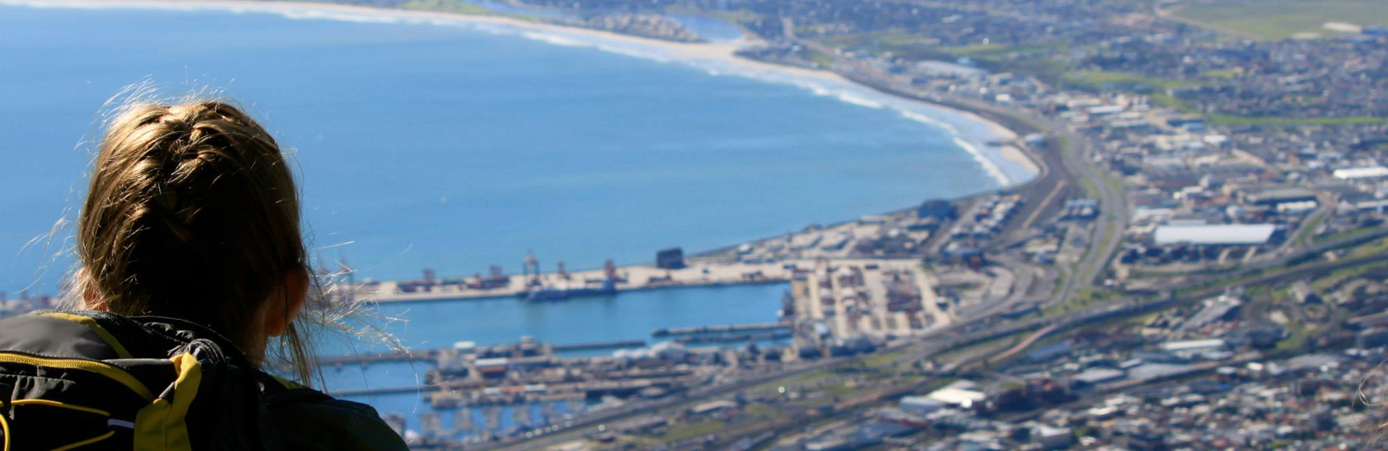 Photo of a student looking out over a port.