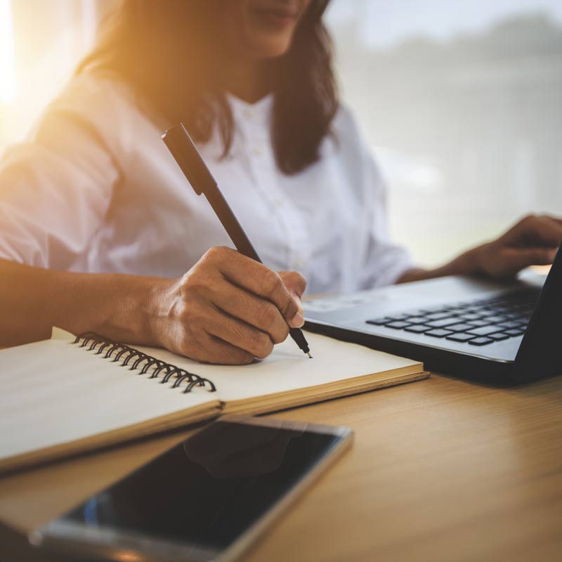 Woman working on laptop.